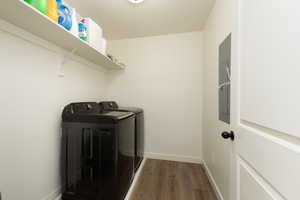 Clothes washing area featuring laundry area, wood finished floors