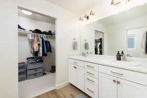 Full bathroom with wood finished floors, double vanity