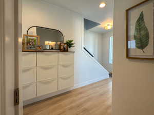 Corridor featuring light wood-style flooring and baseboards