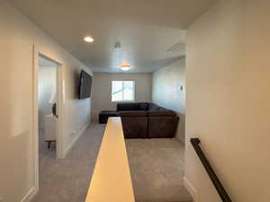 Carpeted living room featuring baseboards and visible vents