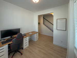 Office with visible vents, baseboards, and light wood finished floors