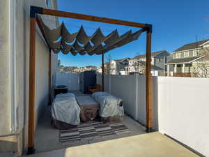 View of patio / terrace with cooling unit, fence, a residential view, and a gate