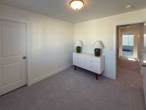 Bedroom featuring carpet flooring and baseboards