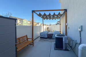 View of patio / terrace with central AC unit and fence