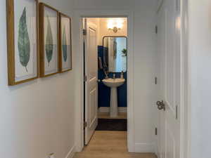 Hall featuring light wood-type flooring and baseboards