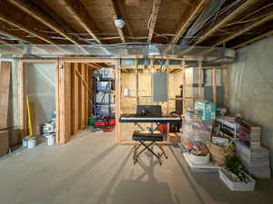 Unfinished basement with electric panel