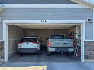 Garage featuring concrete driveway