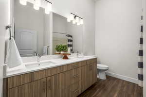 Primary bedroom en suite featuring double vanity and walk in shower
