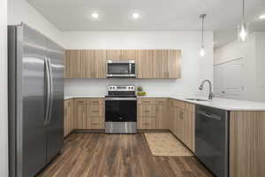 Kitchen featuring beautiful wood style cabinets, quartz countertops, tile backsplash, and stainless steel appliances