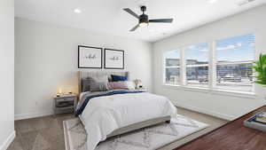 Primary bedroom featuring walk in closet and private en suite