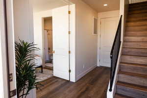 Stairs featuring baseboards, recessed lighting, and wood finished floors