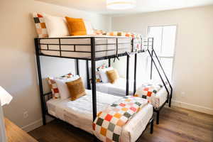 Bedroom featuring baseboards and wood finished floors