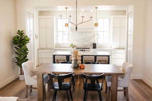 Dining space featuring a wealth of natural light, dark wood-style flooring, and baseboards