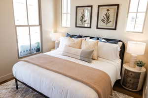 Bedroom with baseboards and wood finished floors