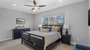 Bedroom featuring baseboards, recessed lighting, and light carpet