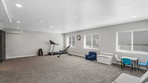 Workout area with baseboards, recessed lighting, carpet, and a textured ceiling