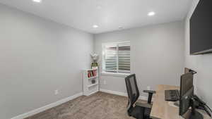 Office area with carpet floors, baseboards, recessed lighting, and visible vents