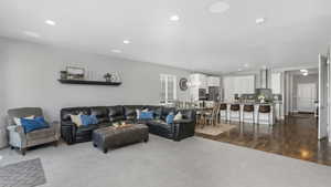 Living area featuring recessed lighting and dark wood-style floors