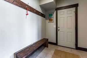 Mudroom featuring baseboards and light tile patterned flooring