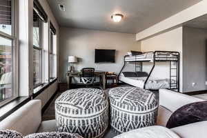 Bedroom featuring visible vents, baseboards, and a textured ceiling