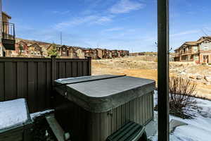 View of yard featuring a residential view, fence, and a hot tub
