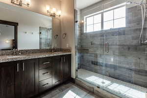 Bathroom with a shower stall and a sink