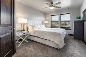 Bedroom featuring ceiling fan, visible vents, baseboards, and carpet floors