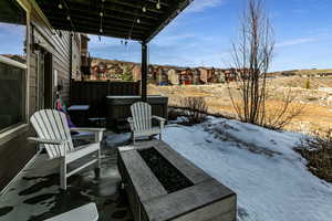 Snow covered patio featuring a residential view
