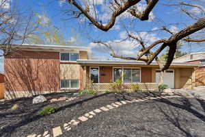 View of front of property with a garage and front yard