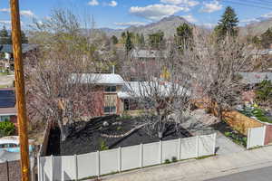 Drone / aerial view of the fenced front yard and house