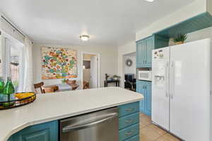 Kitchen looking into dining area, laundry room