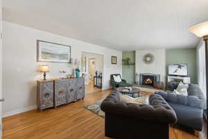 Living area featuring hardwood floors baseboards brick fireplace