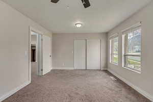 Bedroom #1 with ceiling fan, a closet, visible vents, carpet floors, and baseboards