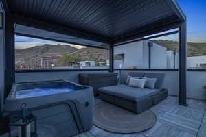 Rooftop deck at dusk - the hot tub lights up in the water