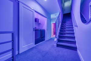 Stairs featuring carpet floors, baseboards, and separate washer and dryer