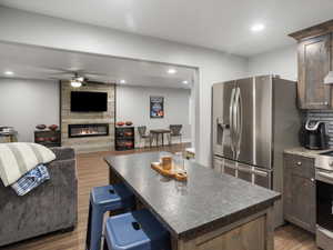 Basement Kitchen with a center island, LVP floors, a ceiling fan, and stainless steel appliances