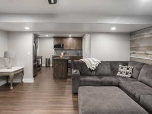 Basement Living room with indoor wet bar, recessed lighting, baseboards, and LVP floors