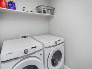 Basement Laundry area featuring laundry area and washing machine and dryer