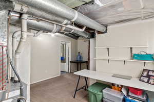 Unfinished basement featuring carpet and baseboards