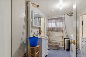 Bathroom with vanity and a textured ceiling