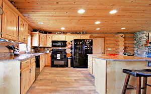 Kitchen featuring wood ceiling, light brown cabinetry, black appliances, and recessed lighting