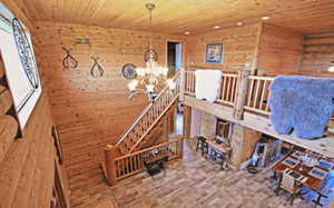 Stairs featuring recessed lighting, wooden walls, a notable chandelier, and wood ceiling