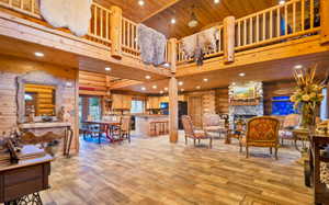Living area with wood ceiling, high vaulted ceiling, recessed lighting, and light wood pattern tile flooring