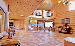 Living area featuring recessed lighting, a towering ceiling, wooden ceiling, and wood pattern tile flooring
