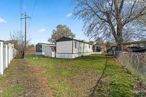 View of yard featuring an outbuilding and a fenced backyard