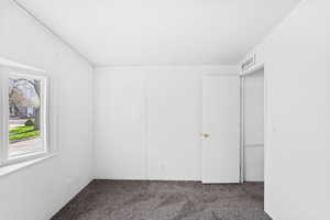Empty room with carpet and visible vents