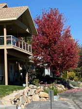 View of home's exterior with roof with shingles and a balcony