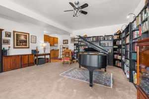 Sitting room featuring light carpet and a ceiling fan