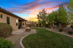 View of yard featuring a patio area, a fire pit, and a fenced backyard