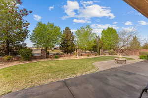 View of yard featuring a fire pit, a patio, and fence private yard